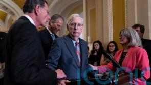 Mitch McConnell helped away from cameras after freezing during press conference