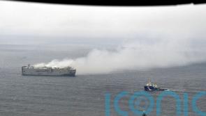 High winds stall efforts to tow burning cargo ship off Dutch coast to safety
