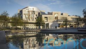 Climate protesters spray Scottish Parliament building red