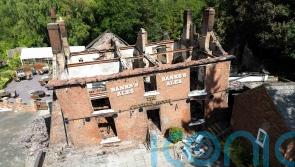 Two men arrested after fire at Crooked House pub