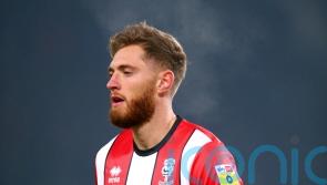 Lincoln move up to fourth with victory over 10-man Blackpool