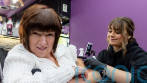 Care home resident and staff fulfil dream with matching tattoos for charity