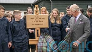King meets pupils learning rural skills after helping to save estate