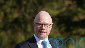Opposition parties call on Donnelly to return from NY amid spinal surgery review