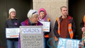 More than 250 climate activists protest with signs to jurors outside courts