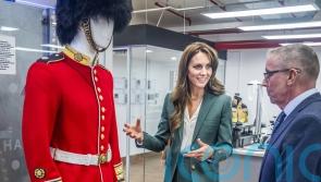 Kate gets the measure of guardsman’s uniform on visit to textile mill