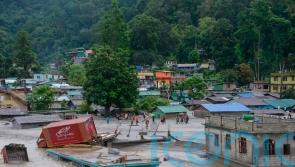 Flash floods kill at least 18 in India and leave nearly 100 missing