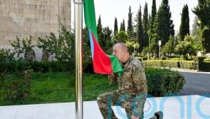 Azerbaijan’s president raises nation’s flag in former breakaway region’s capital