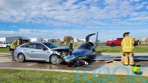 Small plane crashes into car after overshooting runway during emergency landing