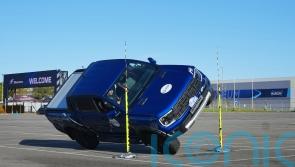 Stunt driver breaks record driving pick-up truck on two wheels through tight gap