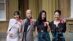 King presents K-pop band Blackpink with honorary MBEs at Buckingham Palace