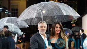 George and Amal Clooney brave British rain for screening of The Boys In The Boat