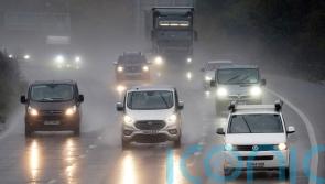 How can I stay safe when driving in heavy rain?