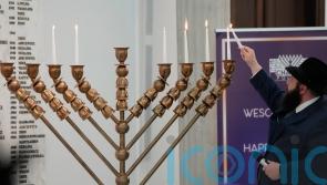 Far-right lawmaker extinguishes Hanukkah candles in Polish parliament