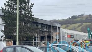 Flowers laid at industrial estate where person died following explosion and fire