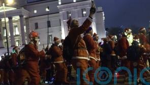 Skaters take over London streets wearing Santa outfits to provide festive cheer