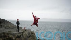 Crowds – including the ‘Forty Foot Santa’ – take part in Christmas Day swim