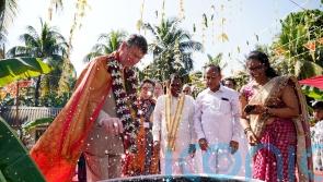 Princess Royal looks on as husband invited to smash coconut in temple visit