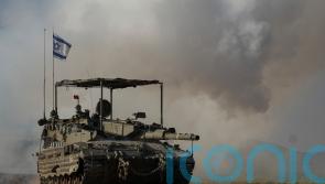 Death toll rises to 12 with dozens injured in a strike on a crowded Gaza shelter