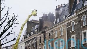 Eight police officers among 11 taken to hospital after fire at five-storey house