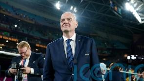 FIFA president Gianni Infantino shows the red card to blue cards