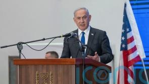 Cracks widen in Netanyahu’s government as top political rival arrives in US