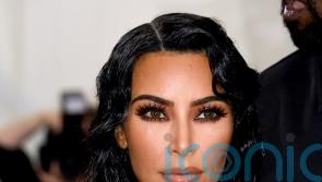 Kim Kardashian wears black dress with Balenciaga price tag left on