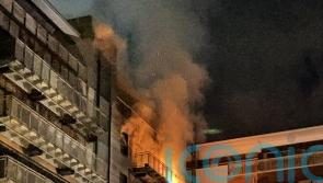Two firefighters injured in flats blaze as around 100 people evacuated