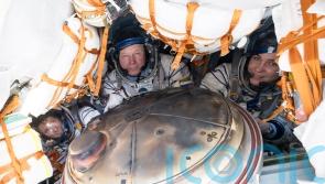 Soyuz capsule carrying three crew from space station lands safely in Kazakhstan
