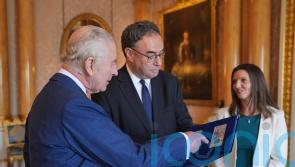 King given first notes featuring his face by Bank of England chief