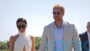 Harry and Meghan spotted hand in hand before charity polo match