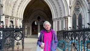 Protester committed contempt by holding sign for jurors to see, High Court told