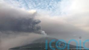 Thousands evacuated and tsunami alert issued after Indonesian volcano eruption