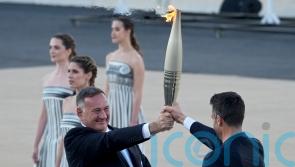 Paris organisers receive Olympic flame at Greek venue of first modern Games