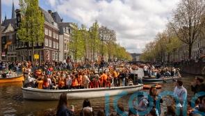 Revellers dress in orange to celebrate Dutch king’s birthday