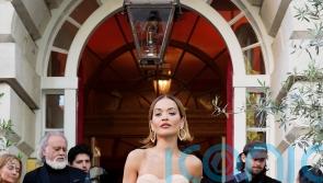 Rita Ora leans into opera glove trend at London launch for new haircare brand