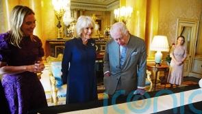 King and Queen view historic Coronation Roll