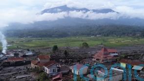 Indonesian rescuers search through rivers and rubble after flash floods