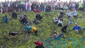 Daredevils defy weather for annual cheese rolling races