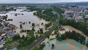 Firefighter dies and train derails amid heavy rain and flooding in Germany
