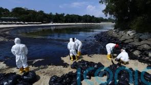 Singapore says dredger lost control and hit tanker causing oil spill
