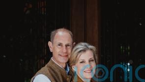 Edward and Sophie embrace in silver wedding anniversary portrait