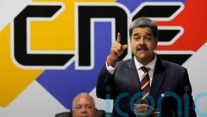 Venezuela’s president says he is resuming negotiations to lift sanctions