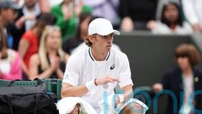 Alex De Minaur reaches first Wimbledon quarter-final but suffers injury scare