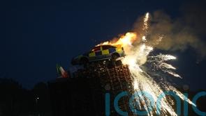 Mock police car burned on top of bonfire