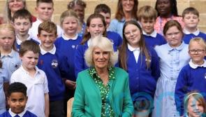 Queen presents children with books during primary school visit