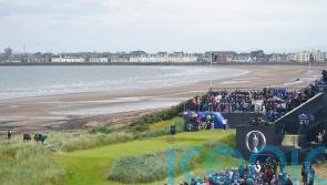 Justin Leonard hits the first shot of the 152nd Open at a cloudy Troon