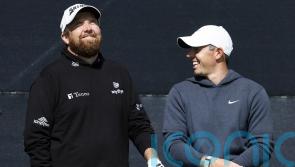 Open day three: Rory McIlroy supporting leader Shane Lowry after missing the cut