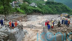 Search for missing after flooding and bridge collapse in China kill at least 25