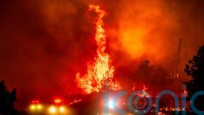 California’s largest wildfire explodes in size as fires rage across US west